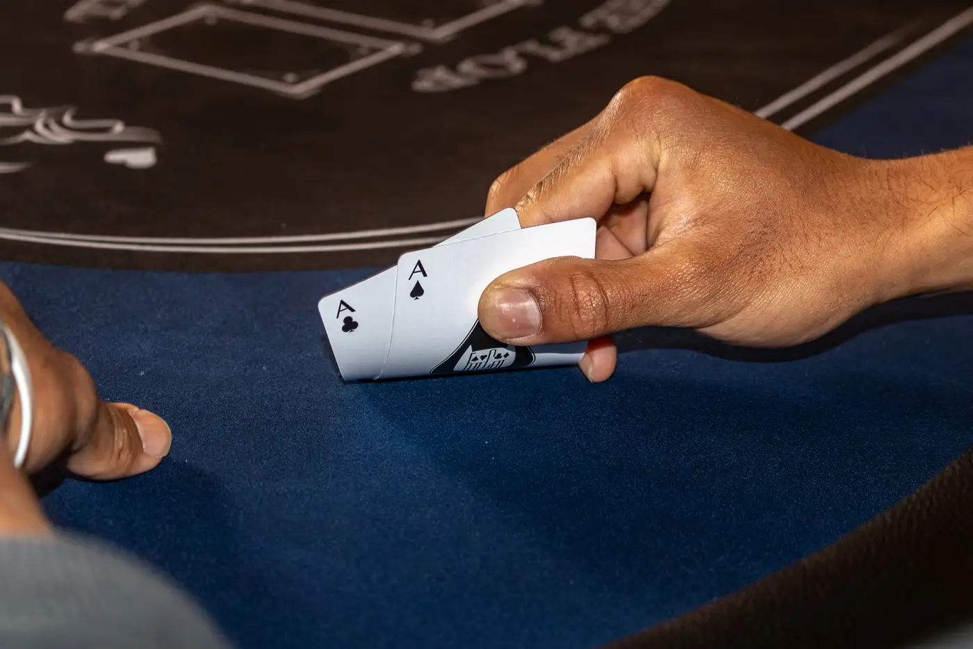 A player peeks at a pair of aces
